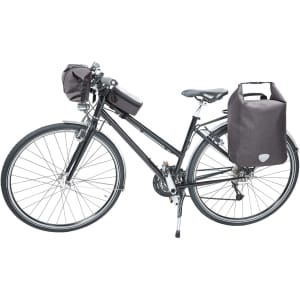 A black bicycle with a handlebar bag and two side bags, all in dark fabric. The bike has a sleek design.