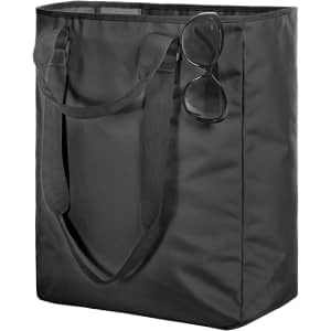A black tote bag with long handles and a pair of sunglasses resting on top.