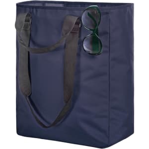 A navy tote bag with black handles, featuring a pair of green sunglasses resting on the side.