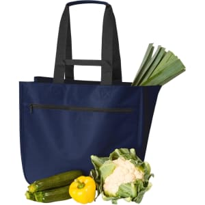 A navy blue tote bag with two handles, containing leeks, zucchini, cauliflower, and a yellow capsicum.