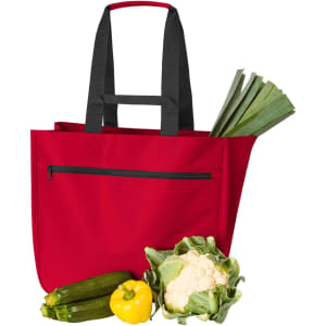 A red tote bag with black handles, accompanied by zucchini, cauliflower, a yellow bell pepper, and leeks.