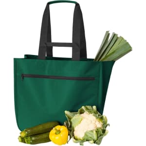 A green Softbasket Shopper bag with black straps, holding leeks, zucchini, a yellow capsicum, and cauliflower.