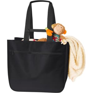 A black tote bag with long handles, featuring a stuffed monkey and a blanket peeking out. It has a logo on it.
