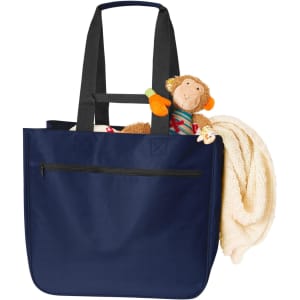 A navy Softbasket Shopper bag containing a soft blanket and a plush monkey toy, with a zipper pocket on the front.