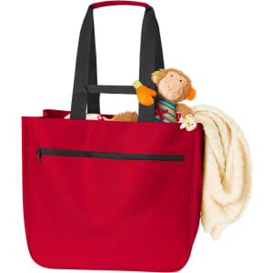 A red tote bag with black straps, featuring a toy monkey and a blanket peeking out from the top.