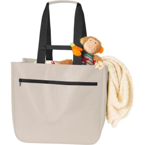 A soft beige bag with black straps, featuring a cuddly toy monkey and a blanket peeking out. It has a zipper pocket.