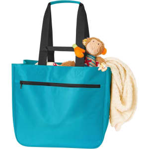 A turquoise tote bag with black straps, featuring a plush monkey toy and a cream blanket inside. It includes a zippered pocket.