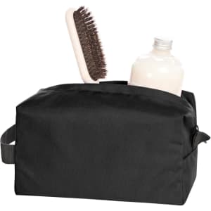 A black toiletry bag with a bottle and a hairbrush inside. Includes a handle for easy carrying.