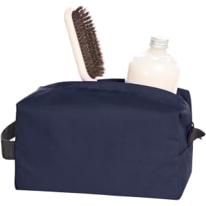 A navy toiletry bag containing a bottle and a hairbrush, featuring a branding logo.