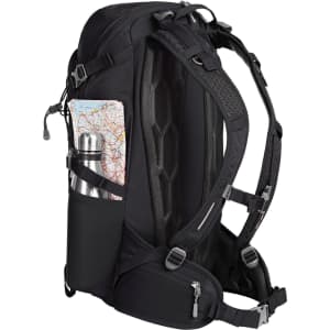 A black outdoor backpack with a water bottle and map visible in its side pockets. Features padded straps and a mesh back.