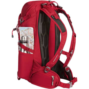 A red outdoor backpack featuring side pockets for a drink bottle and a map, with adjustable straps and mesh detailing.