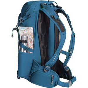 A teal outdoor backpack with adjustable straps, featuring a drink bottle and a map in side pockets.