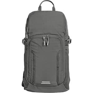 A grey outdoor daypack features multiple zippered compartments and a logo, designed for versatility and convenience.