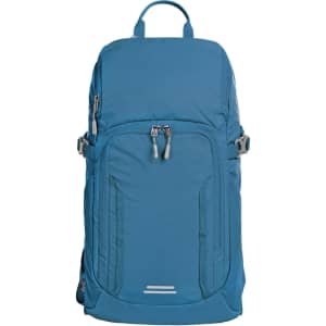A blue outdoor daypack with multiple zippers and adjustable straps, featuring a top handle and a logo.
