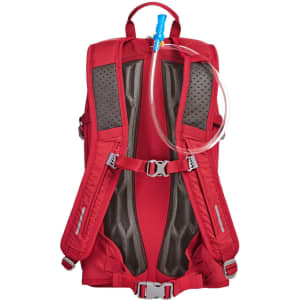 A red outdoor daypack with mesh backing, featuring hydration tubing and adjustable straps. Includes a logo.