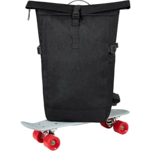 A black Circle Notebook Backpack L positioned on a skateboard, showcasing a minimalist design and adjustable straps.