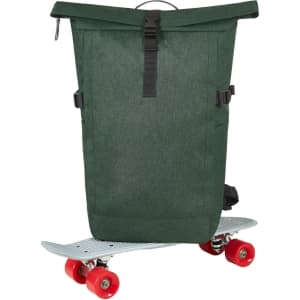 A green roll-top backpack sits on a skateboard, featuring adjustable straps and a logo.