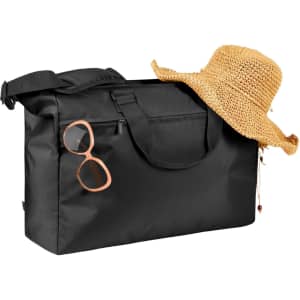 A black duffle bag with a woven straw hat and pink sunglasses resting against it. The bag features a logo.