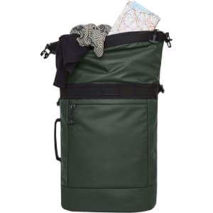 A green Active Notebook Backpack filled with clothing, a map, and other items. It features a logo on the front.