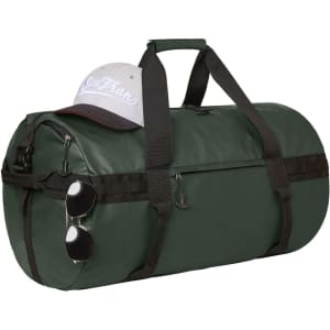 A green duffle bag sits with a grey cap and sunglasses resting on top, featuring a logo.