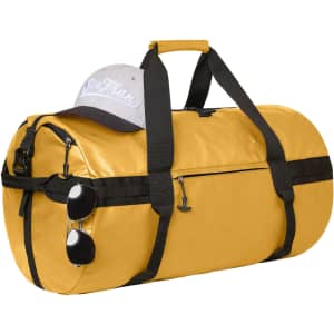A yellow sports/travel bag with black accents, a grey cap, and sunglasses attached to the zipper.