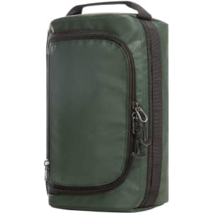 A green wash bag with a zippered front pocket and a handle on top. It features a logo on the side.