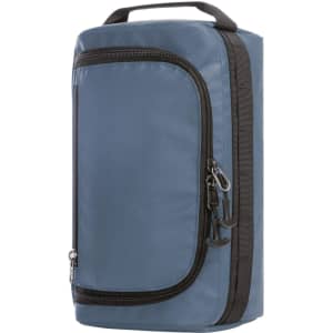 A blue toiletry bag with a zippered compartment and a handle, featuring a logo on the front.