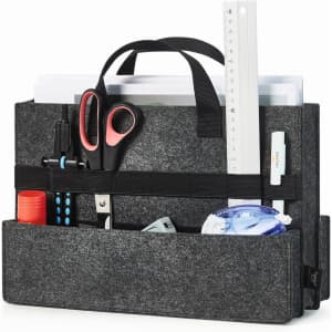 A grey felt bag featuring pockets filled with scissors, stationery, a ruler, and various office supplies.