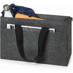 A grey laptop bag contains a drink bottle, folded denim, and a laptop with a document. It has a black strap and logo.