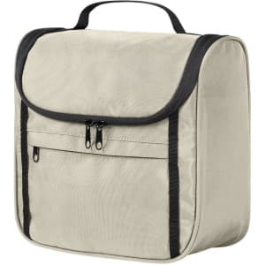 A beige toiletry bag with a flap closure and front zip pocket, featuring a black trim and handle.