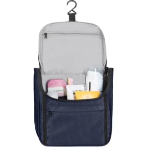 A navy toiletry bag with a hanger, featuring various personal care products and a zippered compartment.