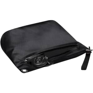 A black dry bag features a zippered closure and a wrist strap, with a set of keys placed inside.