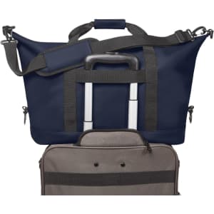 A navy duffle bag with grey accents, featuring a retractable handle and shoulder strap, along with a smaller bag underneath.