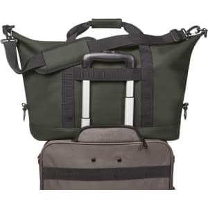 A dark green duffle bag with a handle and shoulder strap, alongside a grey bag. Both have zippers and compartments.