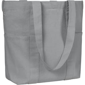 A grey organic tote bag featuring two side pockets and sturdy shoulder straps. It has a simple design with a logo.