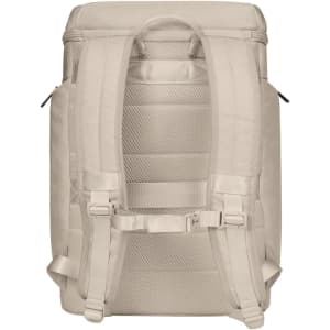 A cream-coloured laptop backpack featuring adjustable padded straps and multiple compartments for storage.