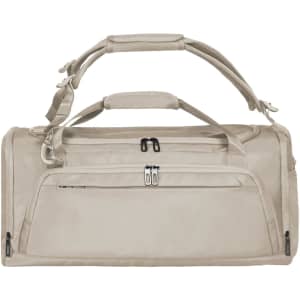 A solid beige duffle bag with multiple carrying handles and a zippered pocket on the front. It features a logo.