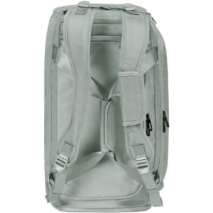 A solid light green duffle bag with multiple compartments and adjustable straps. It features a logo on the side.