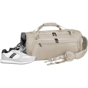 A beige duffle bag with multiple zippered compartments and a detachable strap, accompanied by a pair of white and grey sneakers.