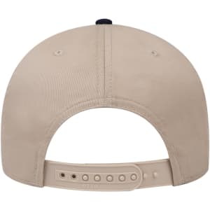 A beige 6 panel low profile baseball cap with a navy accent at the back and an adjustable strap featuring a logo.
