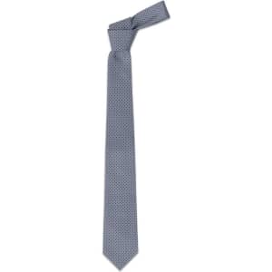 A cravat tie in a light blue colour with a polka dot pattern and a slender design. It features a branding logo.