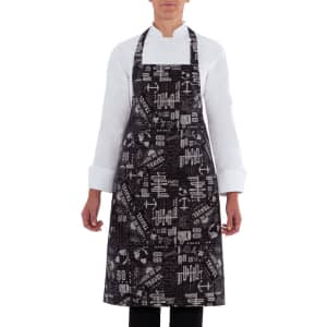 A black apron with a travel-themed pattern, featuring various design elements and a logo.