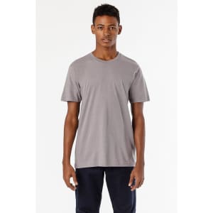 A short sleeve fine jersey crew tee in grey, displayed on a model against a plain background. It has a logo on the front.