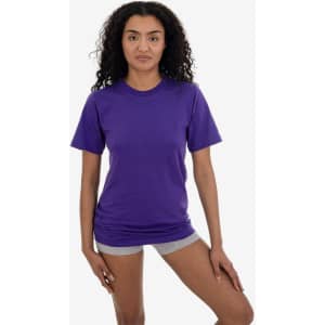 A purple short sleeve fine jersey crew tee displayed on a model, featuring a simple design and a logo.