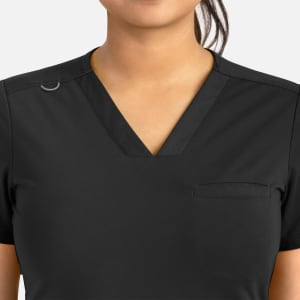 A black women's banded v-neck top featuring a pocket and a small branding logo.