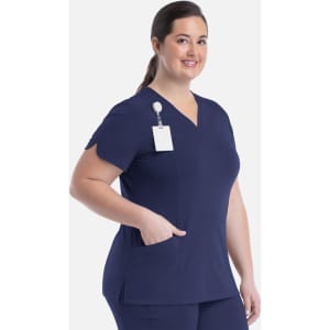 A curved V-neck top in navy blue with a pocket and a name tag holder. Features a logo on the left side.