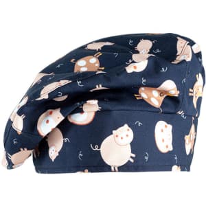 A chef hat featuring a navy background with a playful pig pattern in light colours and a logo.