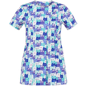 A short-sleeve tunic featuring a playful pattern of cats in shades of purple, blue, and aqua. The design has a logo.