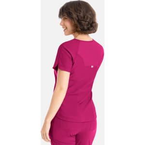 A vibrant pink Y-neck top with short sleeves and a small logo on the back, featuring a snug fit.