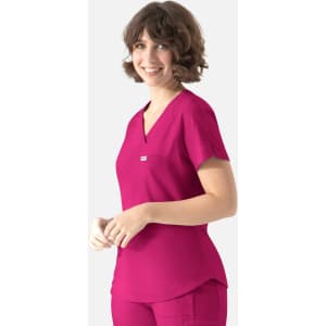 A model wearing a fuchsia Y-neck top with short sleeves and a front pocket, featuring a logo.